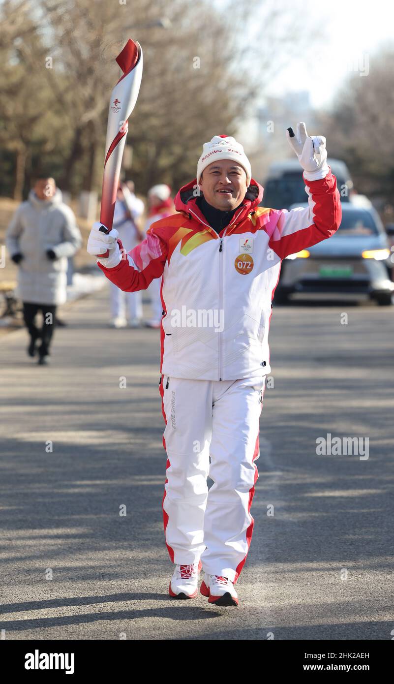 Beijing, China. 2nd Feb, 2022. Torch bearer Chen Haibo runs with the torch during the Beijing 2022 Olympic Torch Relay at the Olympic Forest Park in Beijing, capital of China, Feb. 2, 2022. Credit: Jia Haocheng/Xinhua/Alamy Live News Stock Photo