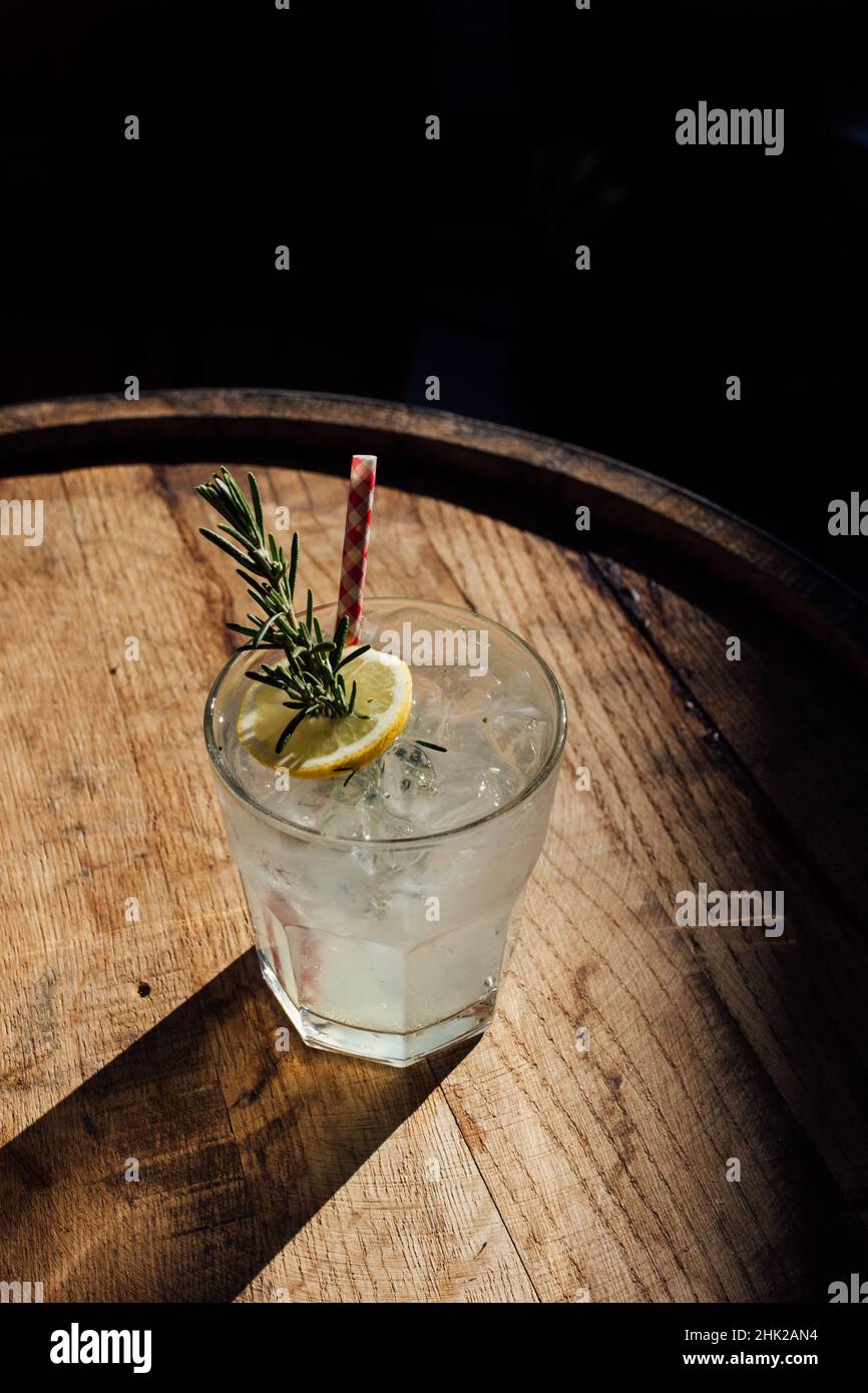 rosemary lemonade soda cocktail with ice and picnic gingham drinking