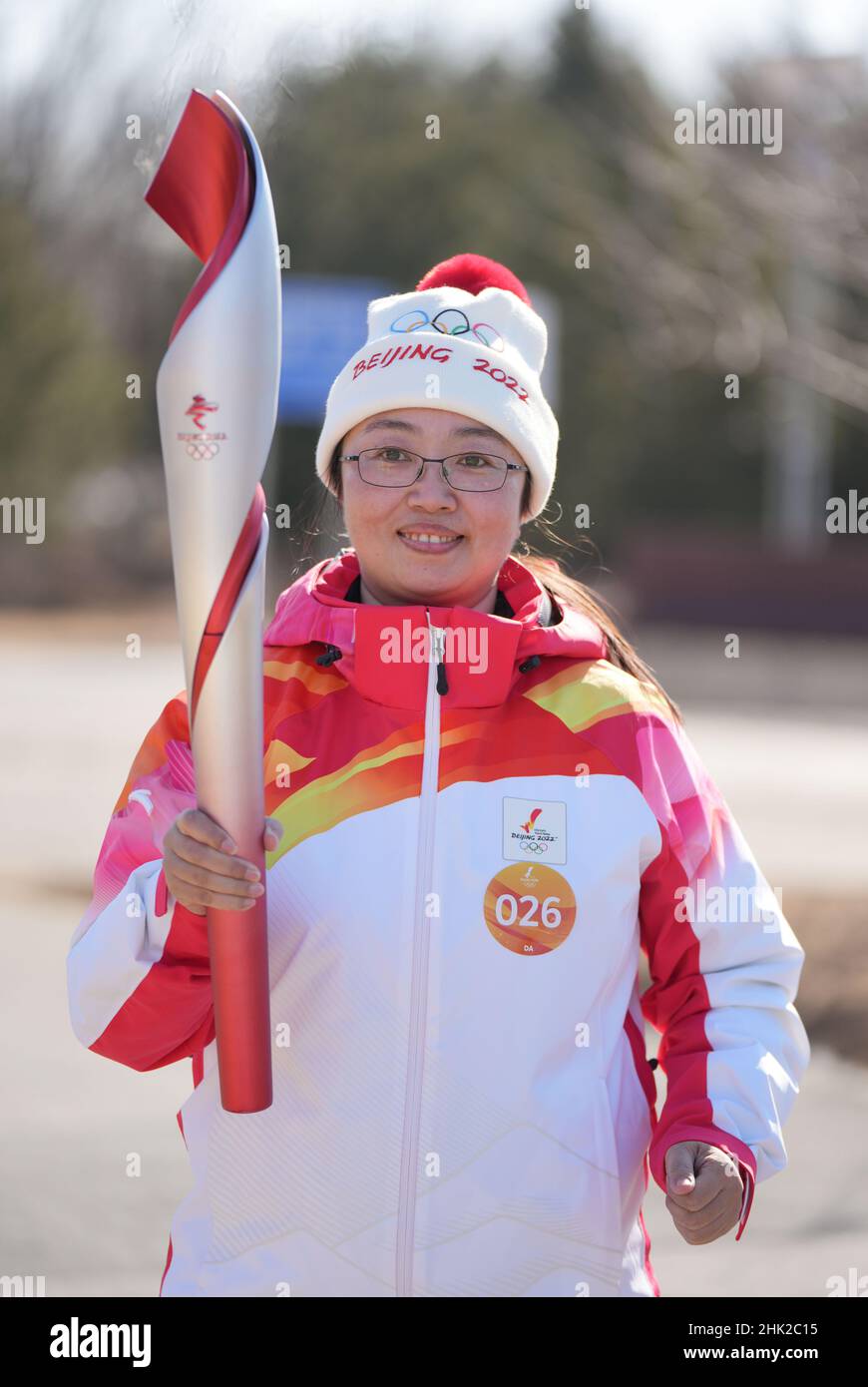 Beijing, China. 2nd Feb, 2022. Torch bearer Guan Xiaonan runs with the ...