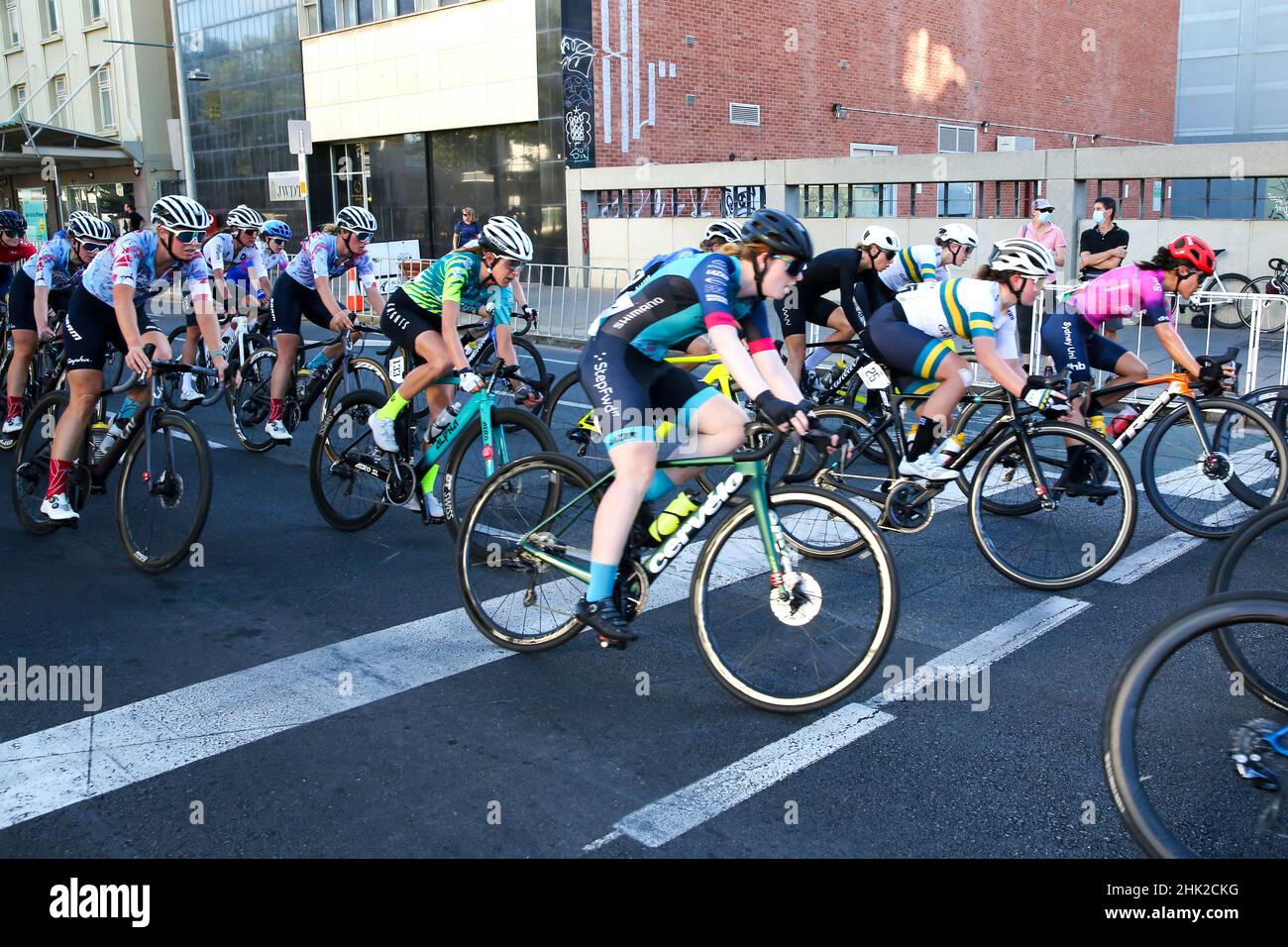 Riders in the Women's Night Rider's Criterium negotiation the streets of Adelaide for the 2022 Festival of Cycling in Australia Stock Photo