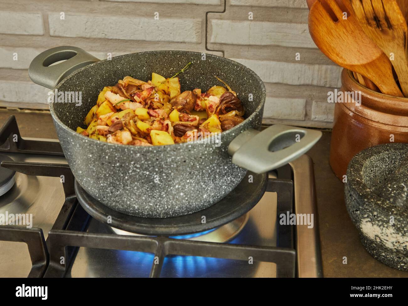 Making Alsatian sauerkraut in saucepan on a gas stove. French gourmet