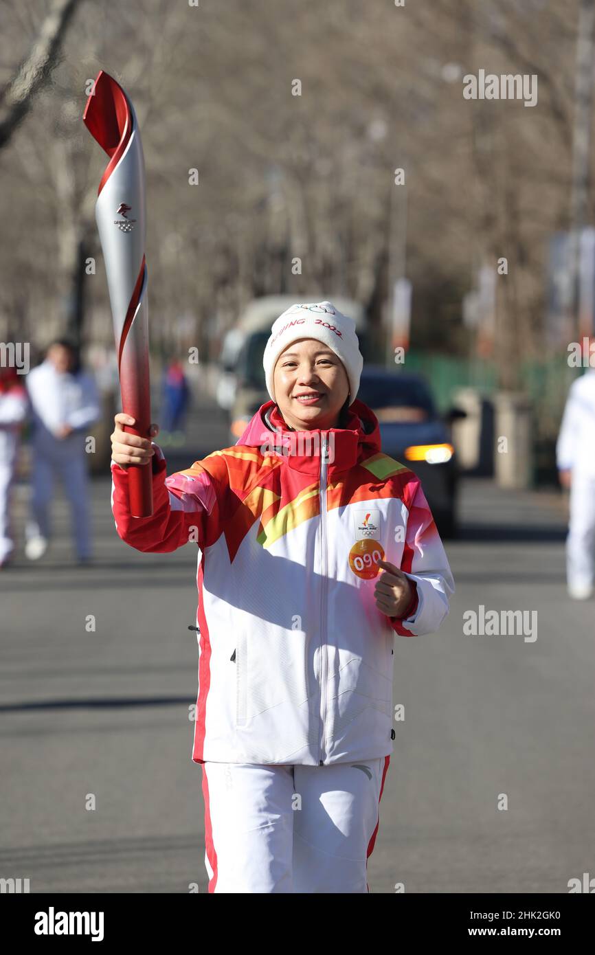Beijing, China. 2nd Feb, 2022. Torch bearer Li Xiaohua runs with the ...