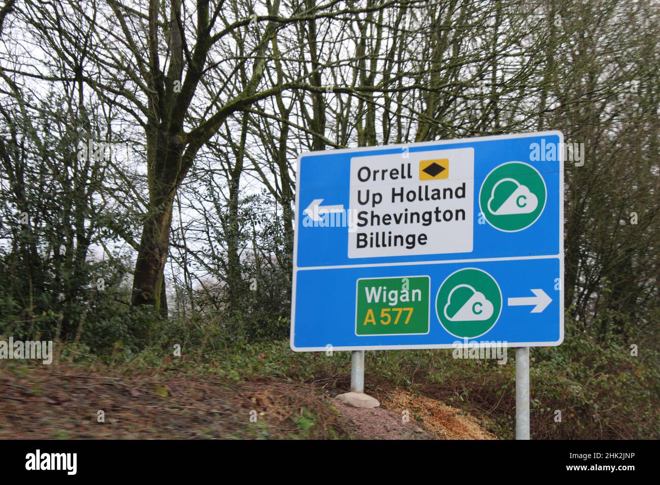 Clean air one sign with white arrows pointing to Wigan A577 and Orrell, Up Holland, Shevington and Billinge Stock Photo