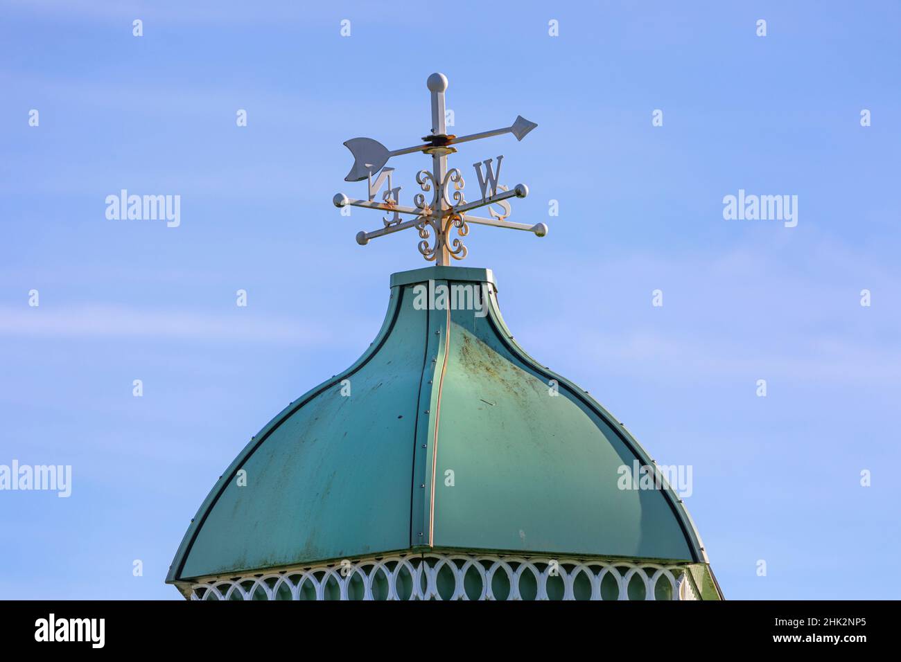 A rusting weather vane on a small pagoda roof Stock Photo