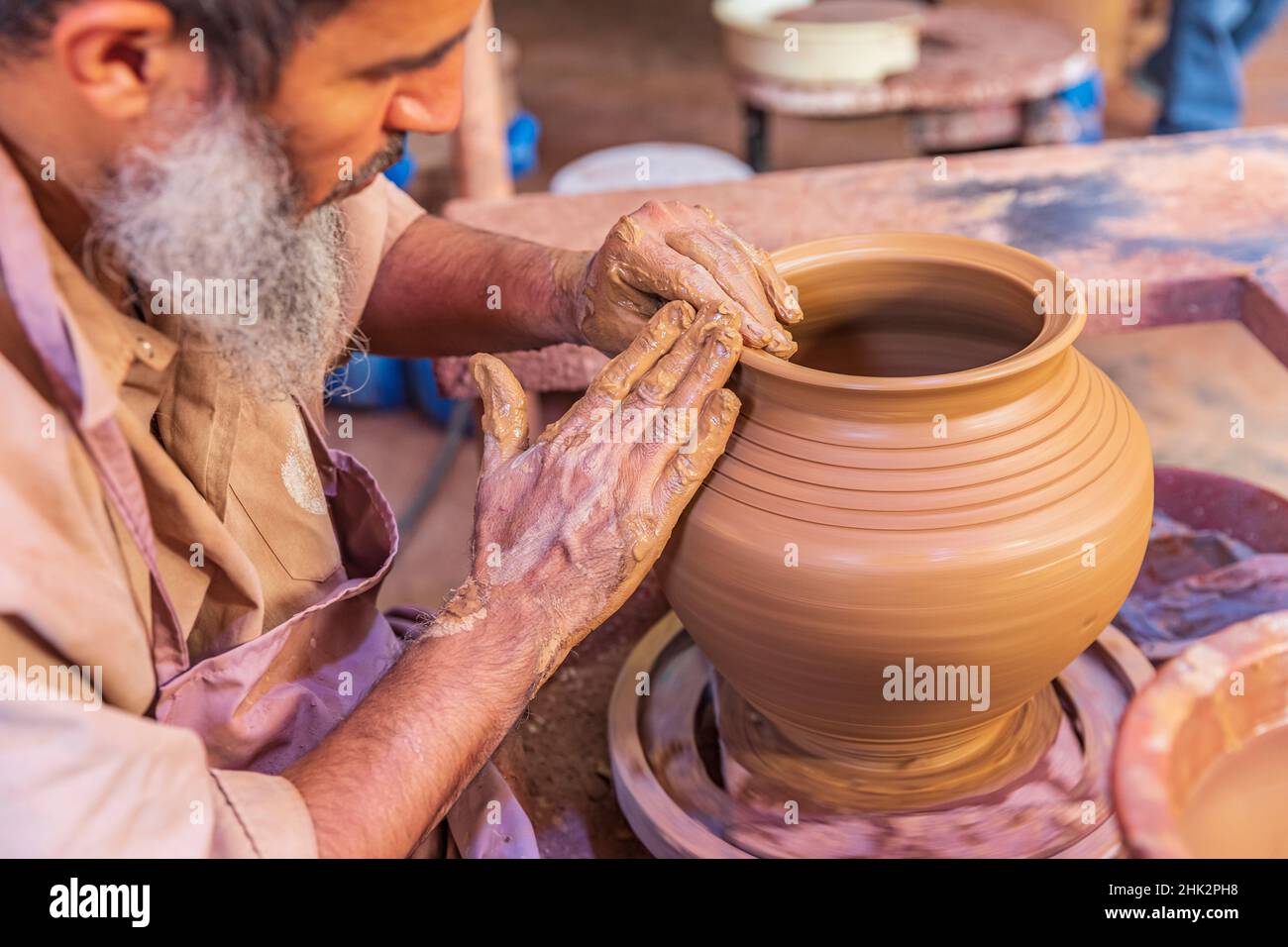 Middle East, Arabian Peninsula, Oman, Ad Dakhiliyah, Bahla. Man working