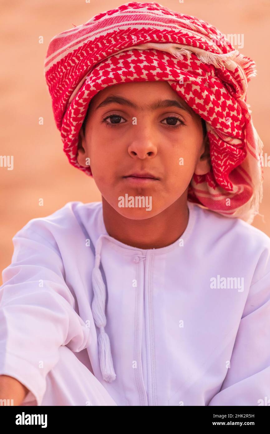 Middle East, Arabian Peninsula, Ash Sharqiyah North, Bidiyah. Boy on a sand dune in the desert of Oman. (Editorial Use Only) Stock Photo