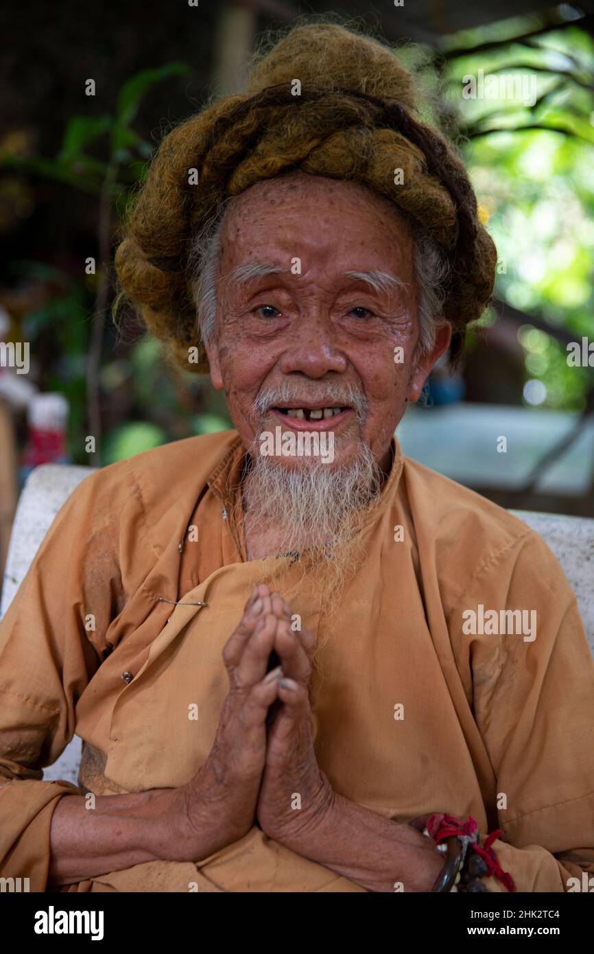 Vietnam. 92 year old man from the Phat Giao Hoa Hao, Vietnamese Buddhist religious movement. His hair has grown to 5 meters over the last 60 years. Stock Photo