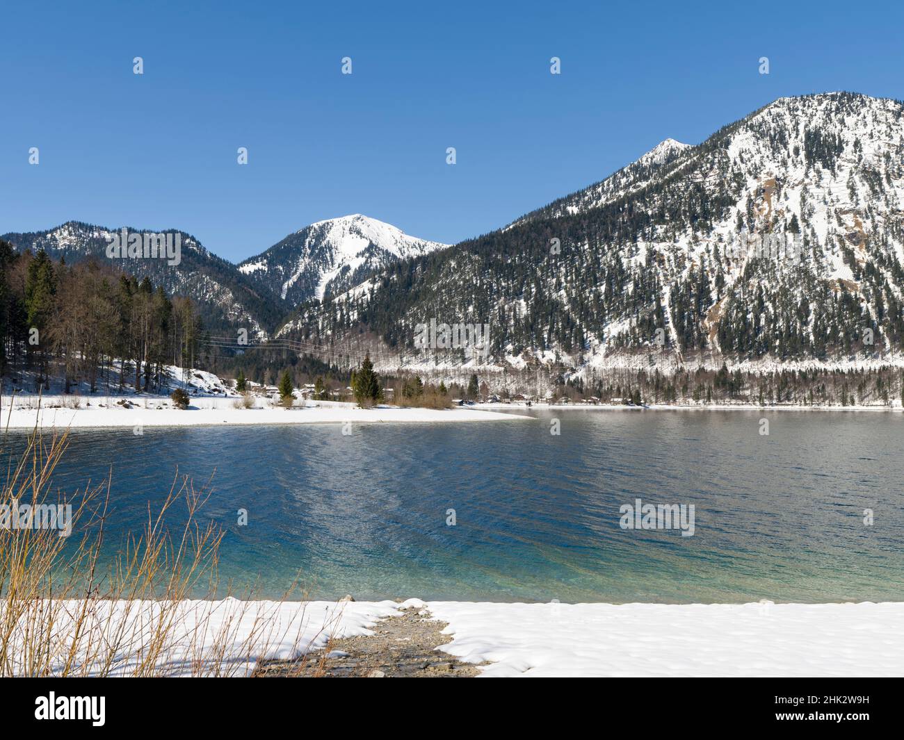 View towards village Walchensee, Mt. Herzogstand and Mt. Heimgarten. Lake Walchensee in the snowy Bavarian Alps. Germany, Bavaria Stock Photo