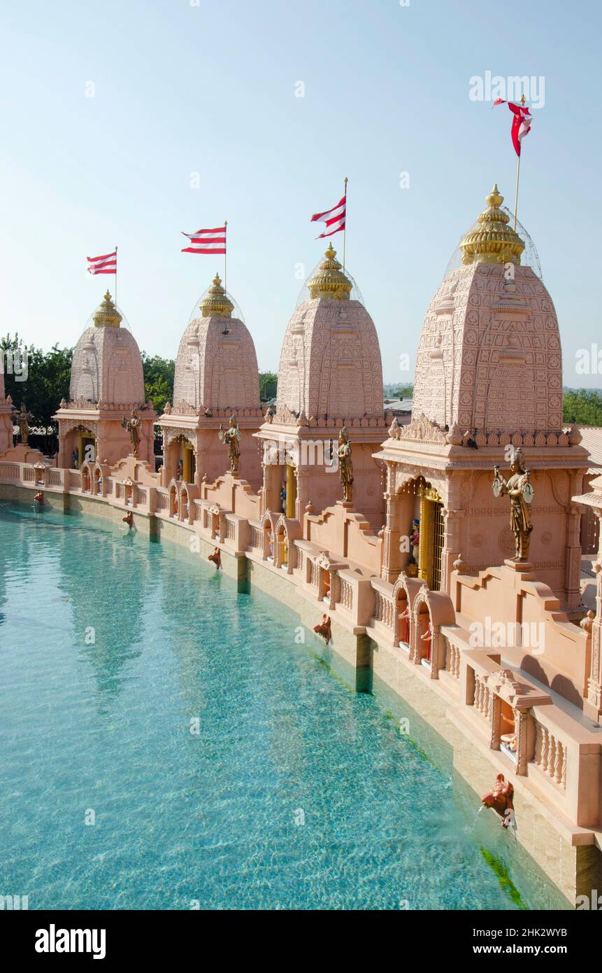 Sandstone mandapas around the artificial lake at Neelkanth Dham Swaminarayan Temple, Poicha, Gujarat, India, located at Poicha, Gujarat, India Stock Photo