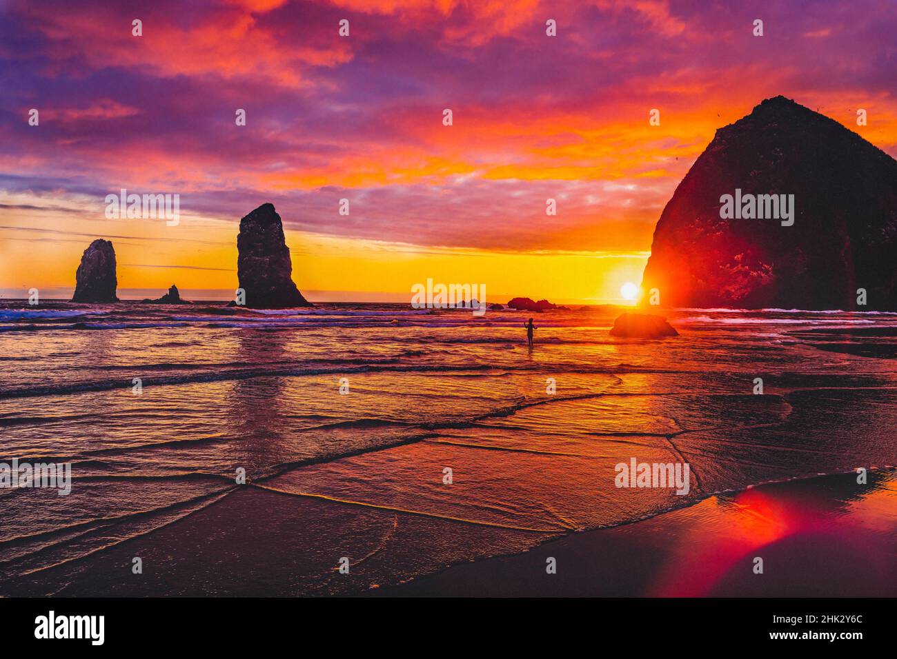 Colorful sunset, Haystack Rock sea stacks, Canon Beach, Clatsop County, Oregon. Originally discovered by Clark of Lewis Clark in 1805 Stock Photo