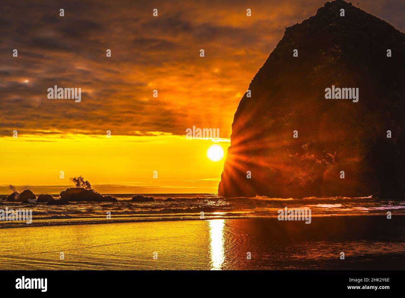 Colorful sunset, Haystack Rock sea stacks, Canon Beach, Clatsop County, Oregon. Originally discovered by Clark of Lewis Clark in 1805 Stock Photo