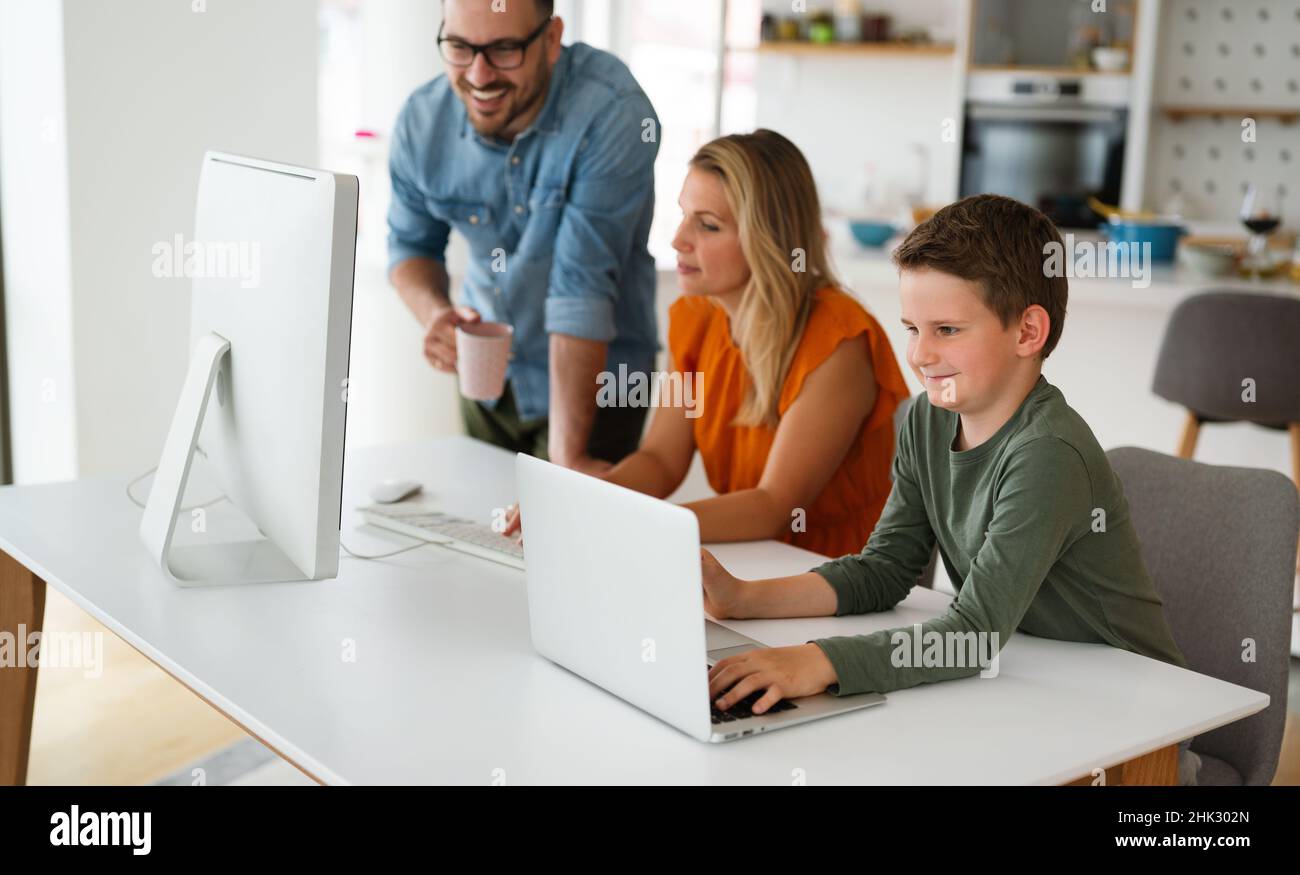 Happy family parent and child at home working on the computer. Business