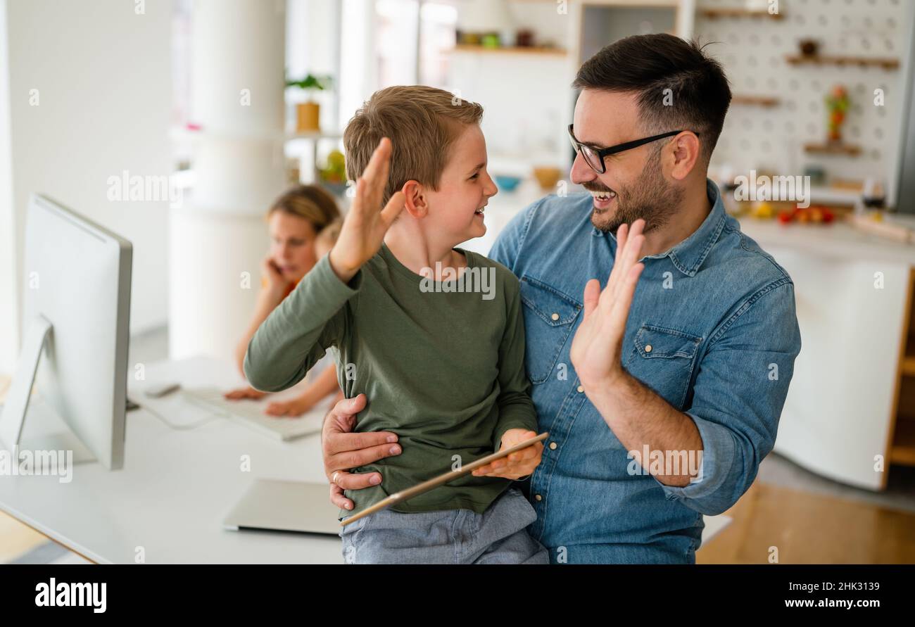 Father and child using digital tablet for e-learning. Education home digital device kid concept. Stock Photo