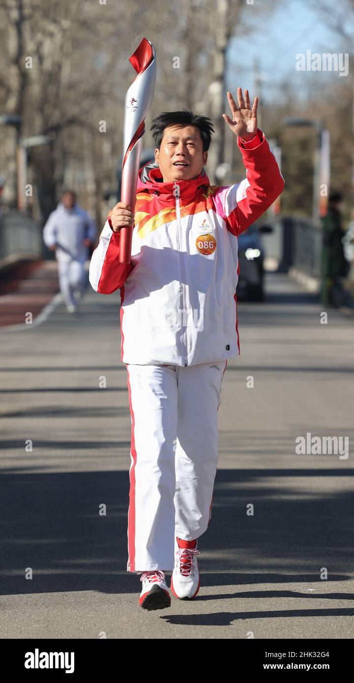 Beijing, China. 2nd Feb, 2022. Torch bearer Liu Jinsong runs with the ...
