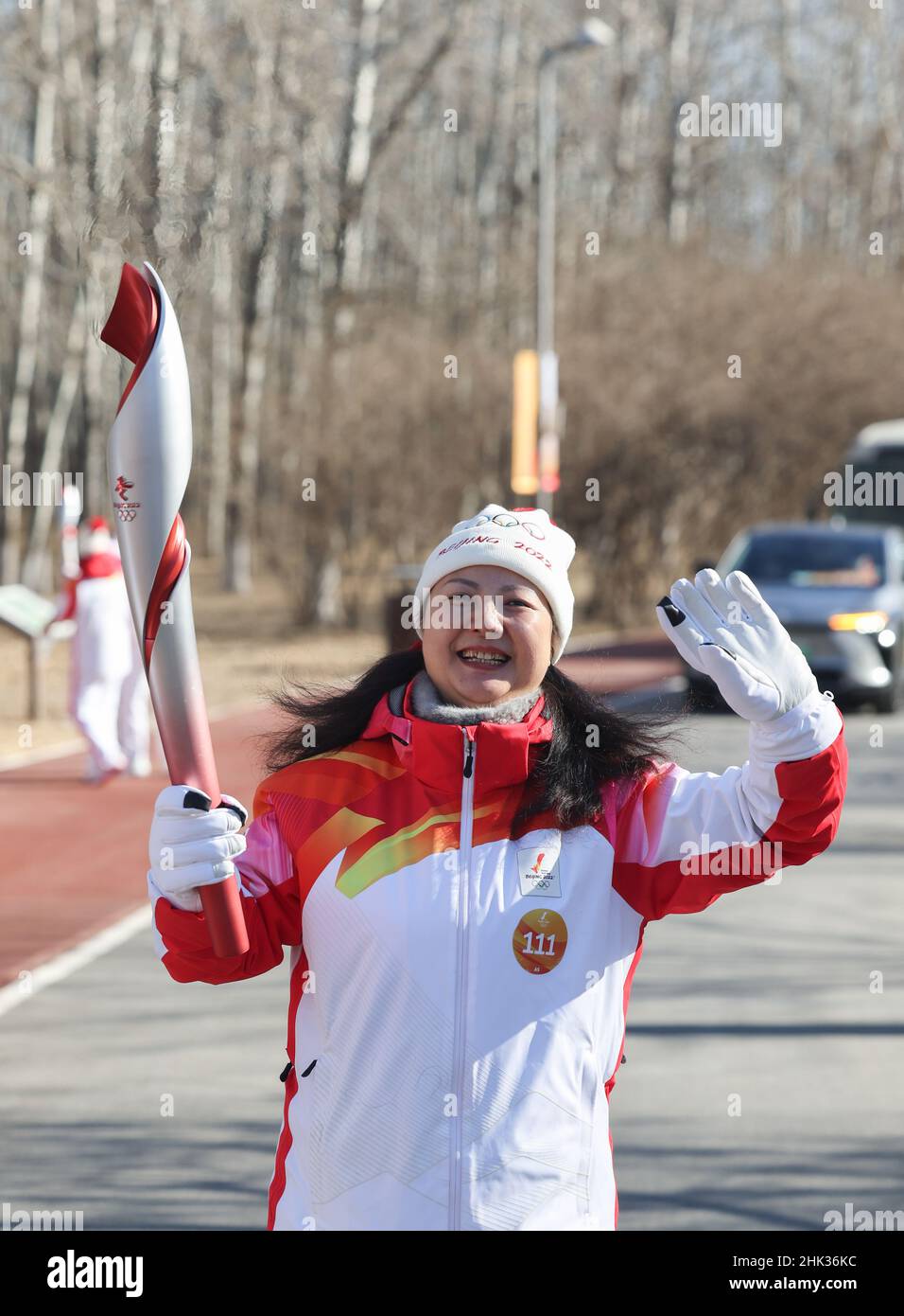 Beijing, China. 2nd Feb, 2022. Torch bearer Chen Lihua runs with the ...