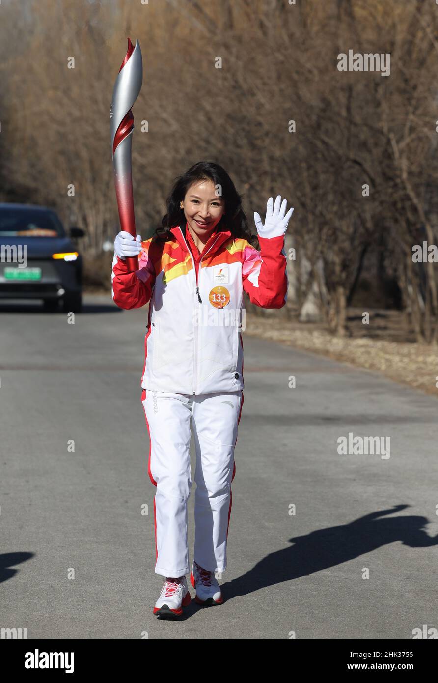 Beijing, China. 2nd Feb, 2022. Torch bearer Wang Xiaojie runs with the ...