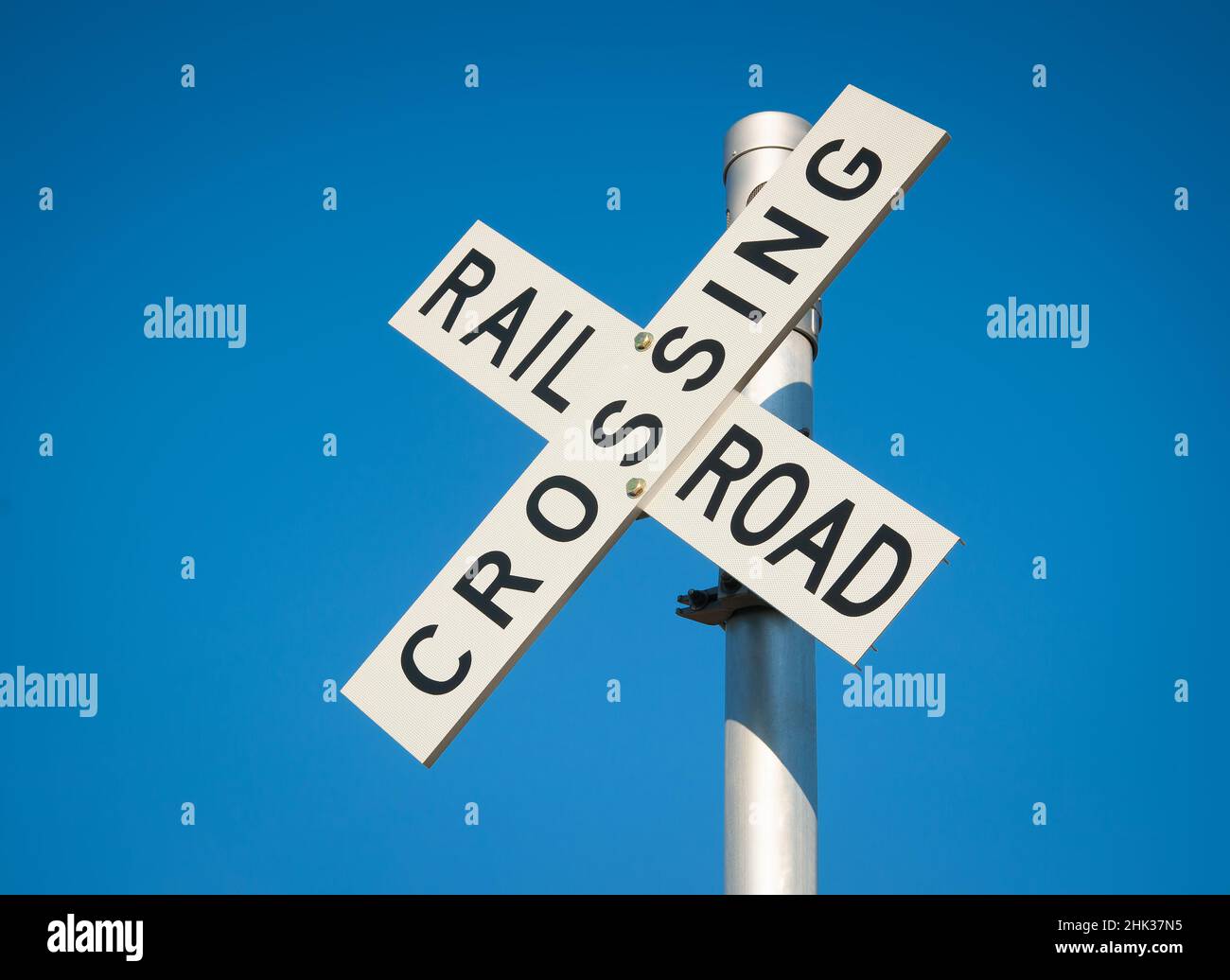 Railroad crossing sign on rural road Stock Photo