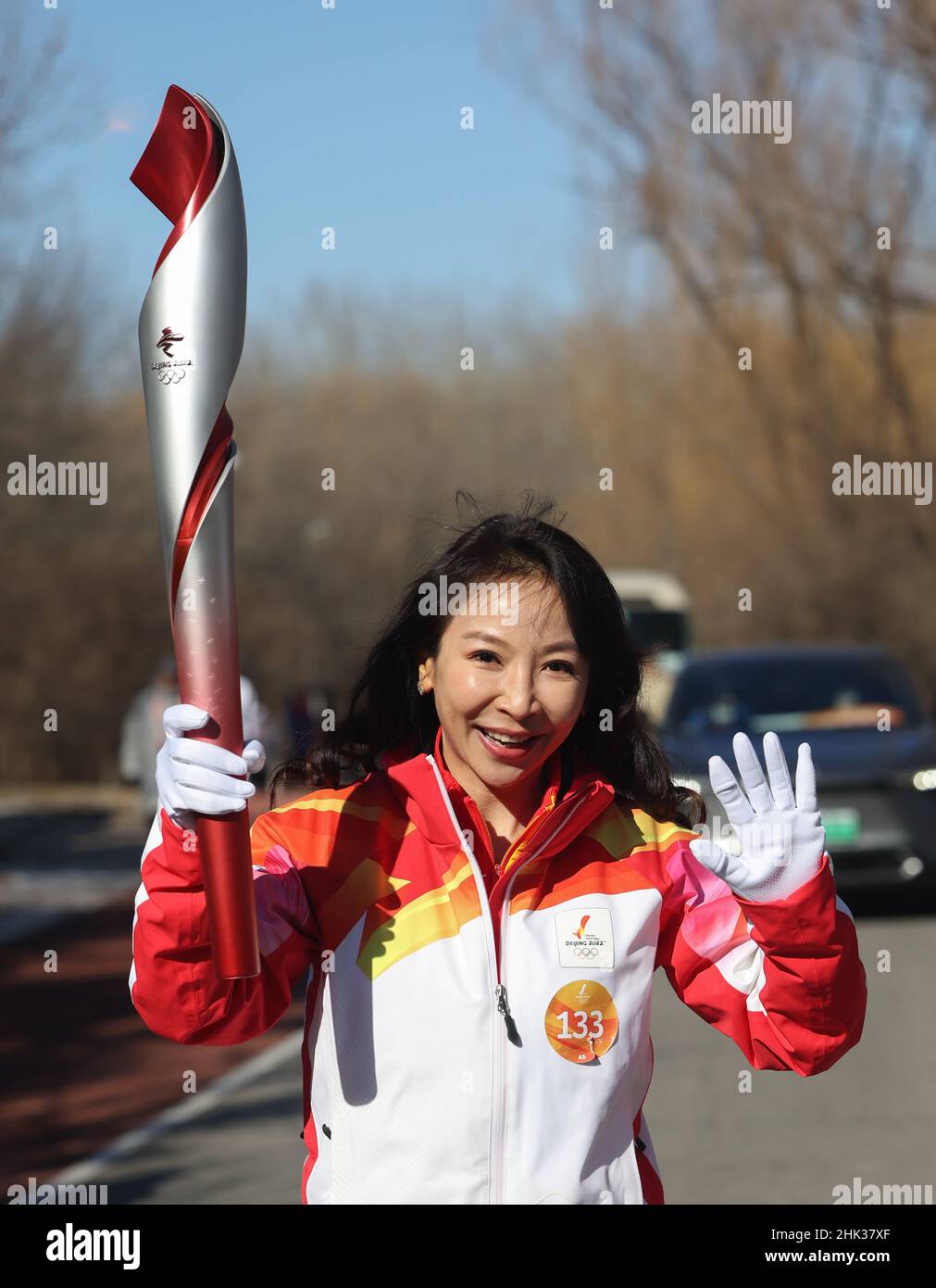 Beijing, China. 2nd Feb, 2022. Torch bearer Wang Xiaojie runs with the ...