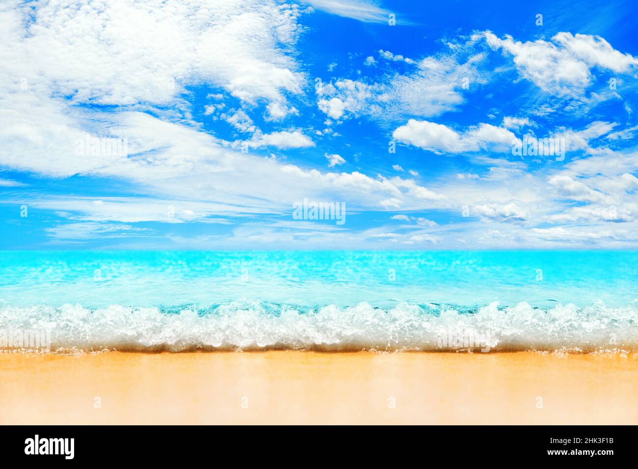 Beautiful tropical island beach panorama, turquoise sea water, ocean wave splash, yellow sand, sun blue sky white clouds, summer holidays, vacation Stock Photo