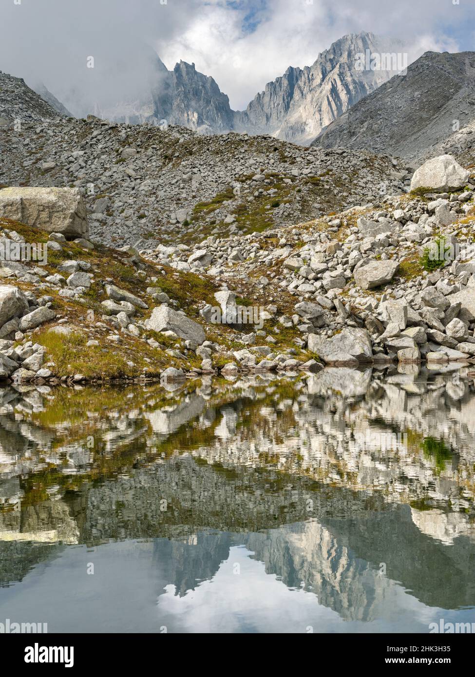 View towards Cima Presanella draped in clouds near Rifugio Segantini. Presanella mountain range, Parco Naturale Adamello, Brenta, Trentino, Italy, Val Stock Photo