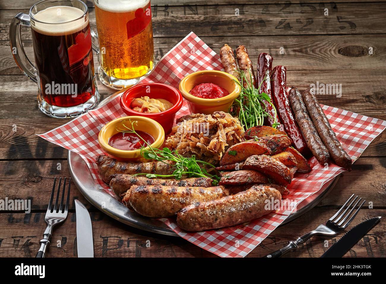 Fried sausages, potato wedges, stewed cabbage, sauces as beer snack