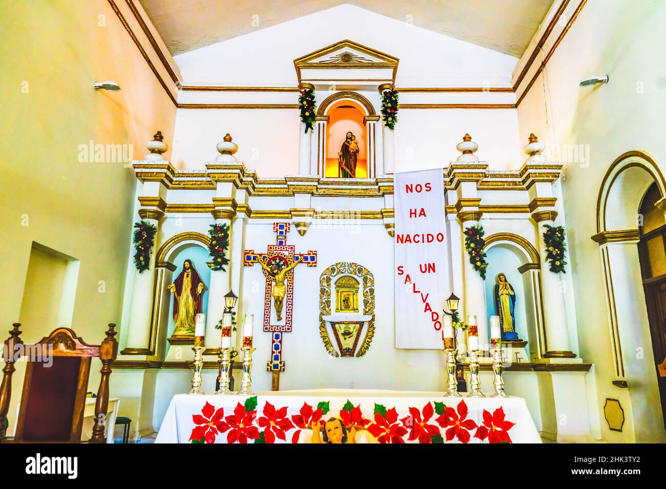 Basilica altar Christmas Decorations, Mission San Jose del Cabo, Mexico. Spanish words above altar 'A savior has been born to us'. Mission founded 173 Stock Photo