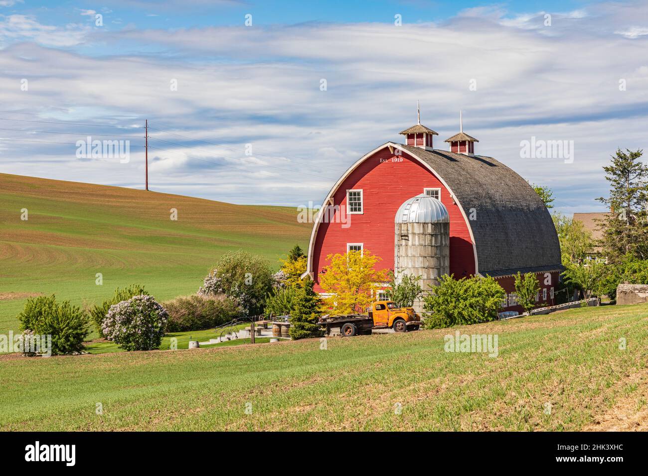 Colfax, Washington State, USA. Red barn and grain silo on a farm in the