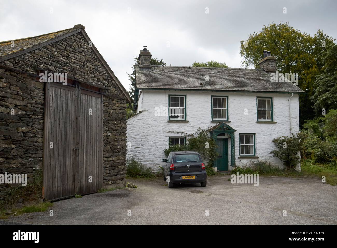 traditional whitewashed stone farmhouse cottage and barn near sawrey lake district, cumbria, england, uk Stock Photo