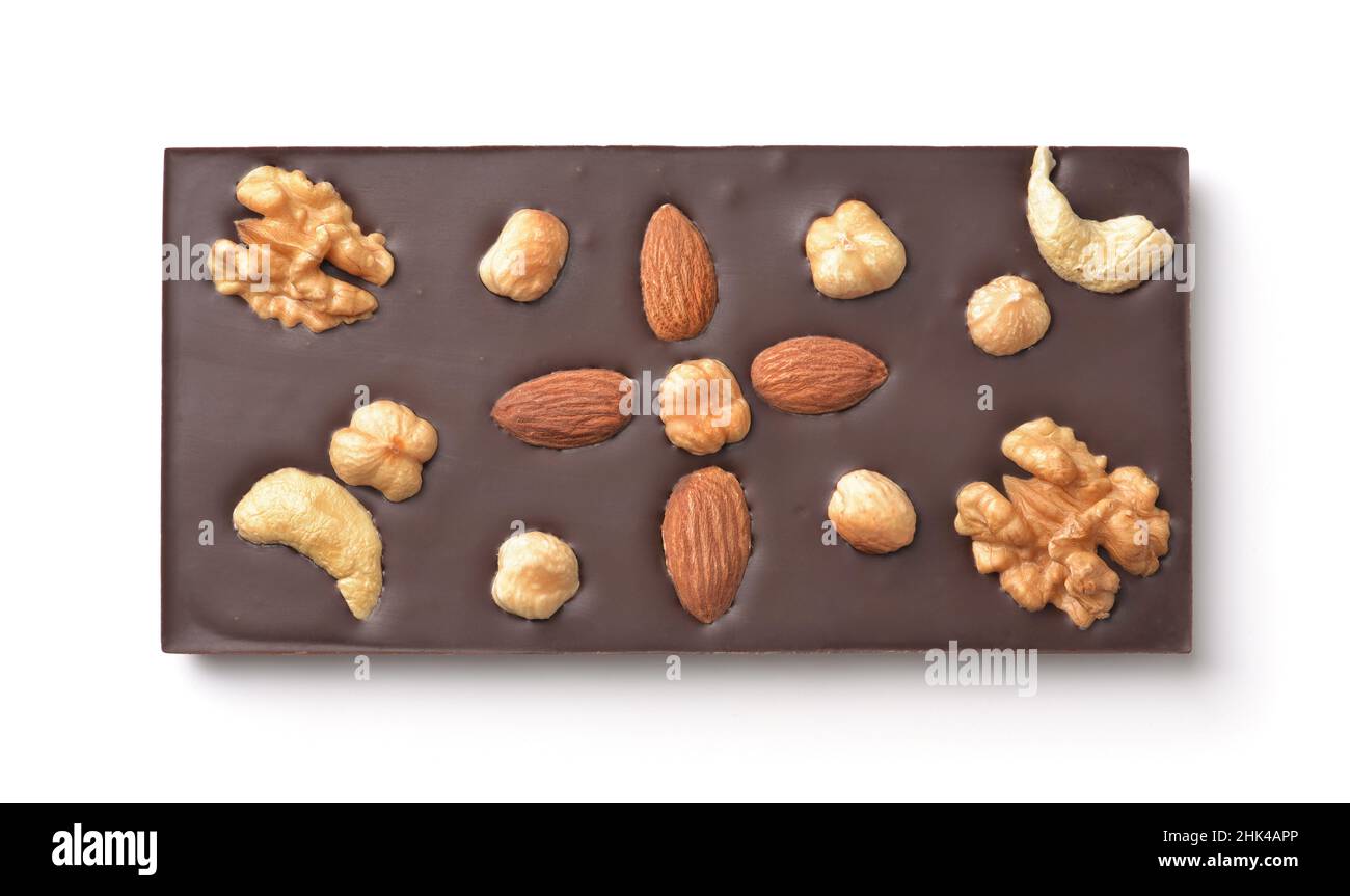 Top view of handmade chocolate bar with whole almond, hazelnut, walnut and cashew isolated on white Stock Photo