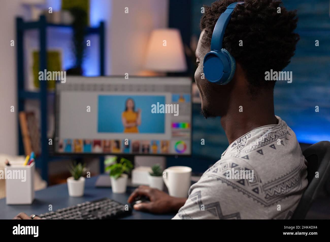 African american editor editing picture using retouching software
