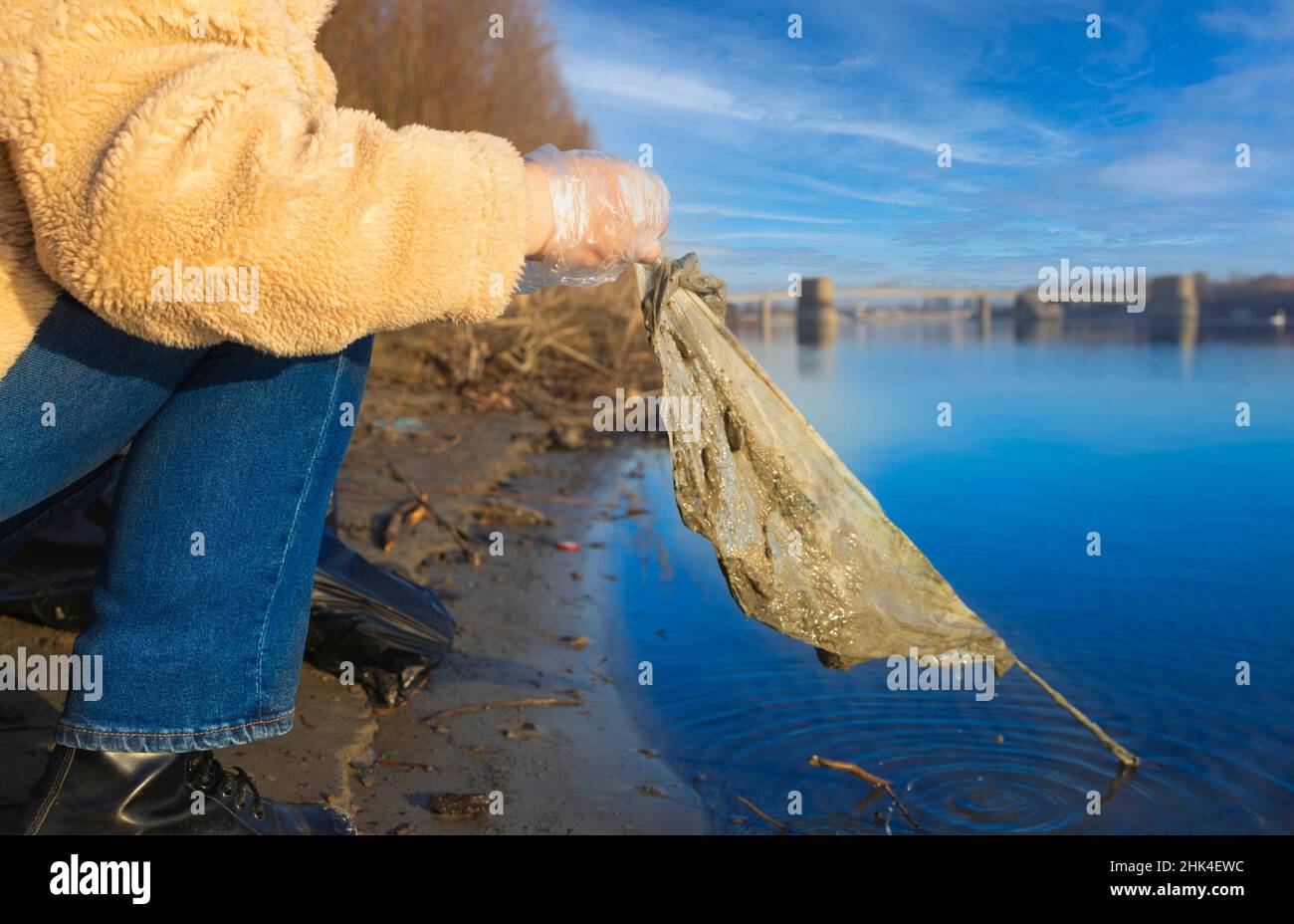 Detail of a trash bag being picked up from a river Stock Photo Alamy