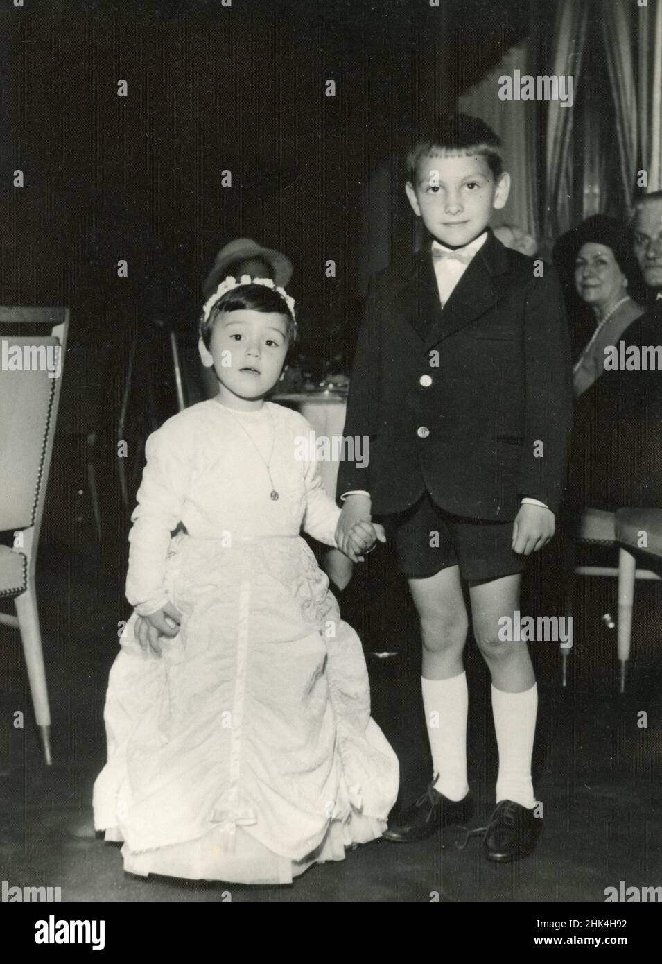 Wedding in Italy during the 1950s: The youngest couple among the guests Stock Photo