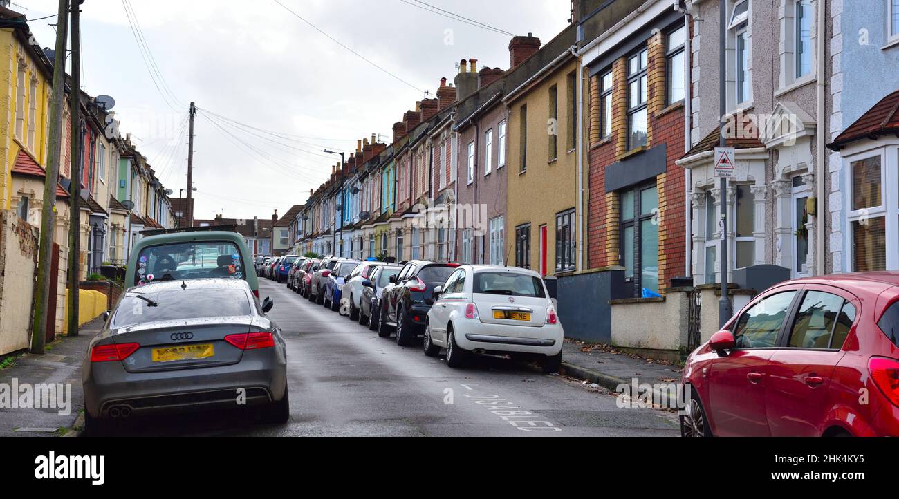 Small residential street in city with cars parked on both sides of the narrow road, Bristol, UK Stock Photo