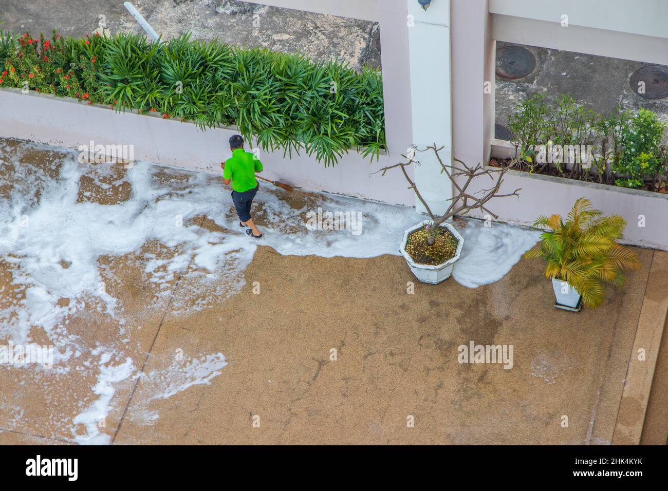 A cleaning crew at work maintaining and tidying up the pool of a condominium or hotel and its associated grounds Stock Photo