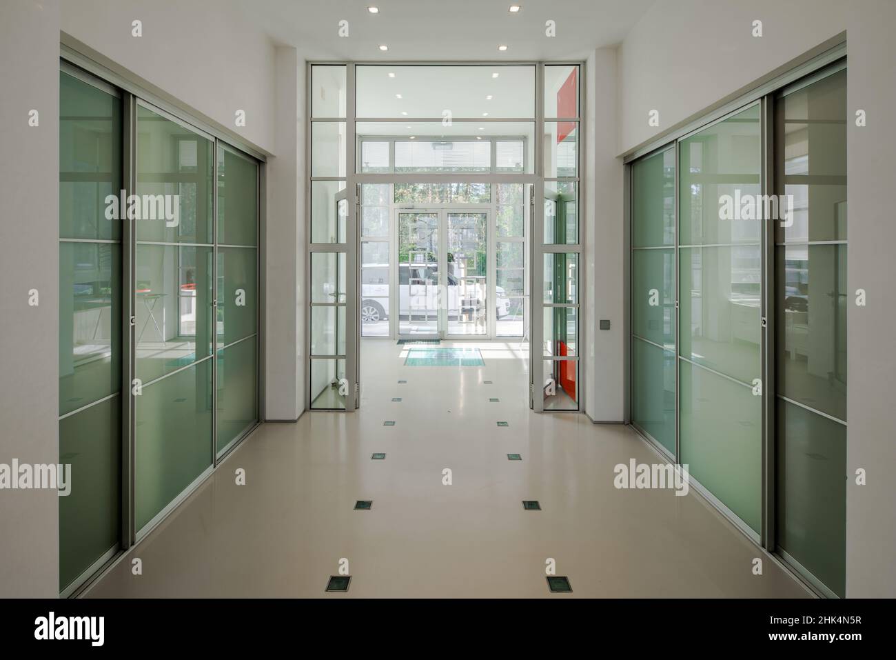 Modern interior of spacious hall in luxury private house. Glass sliding ...