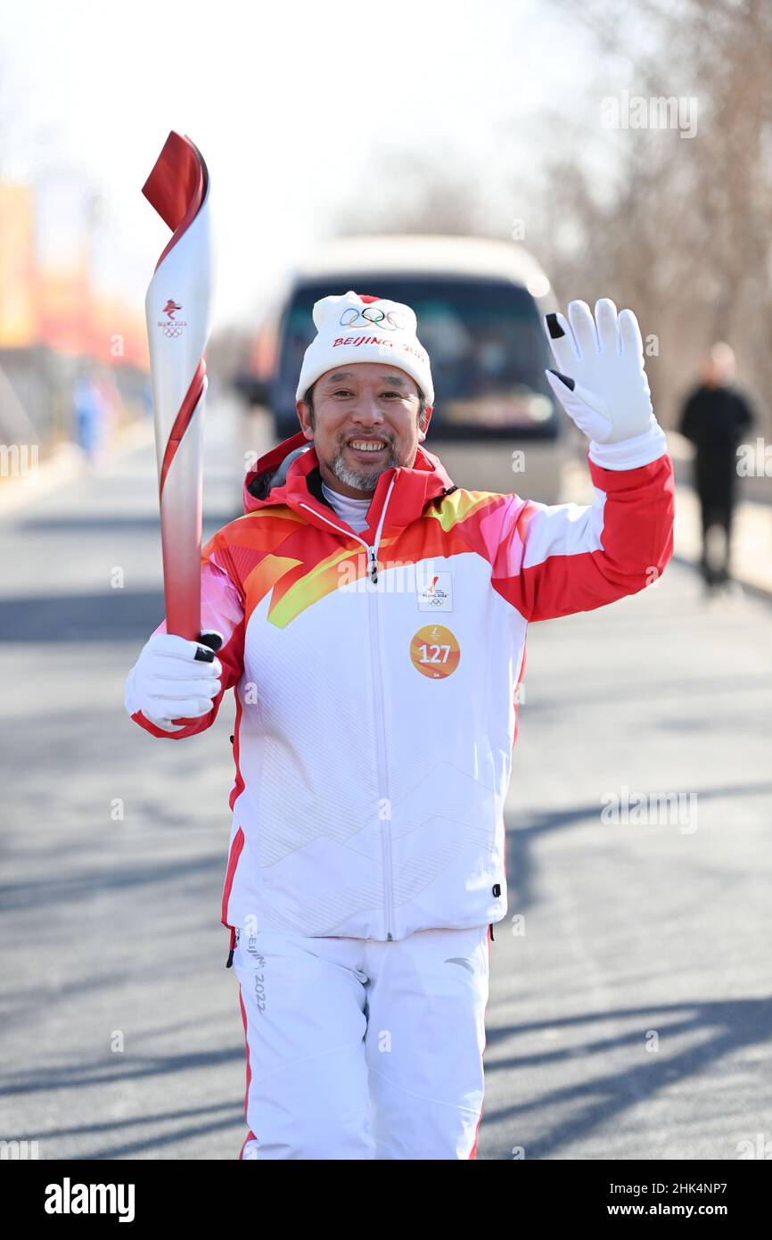 Beijing, China. 2nd Feb, 2022. Torch bearer Zhou Chenguang runs with ...