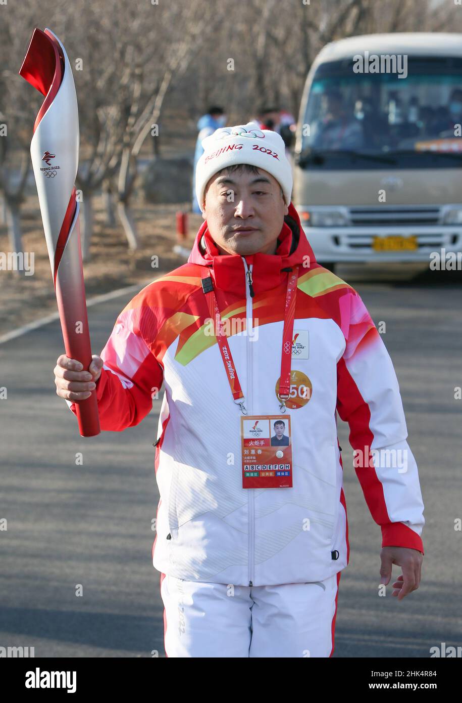 Beijing, China. 2nd Feb, 2022. Torch bearer Liu Huichun runs with the ...