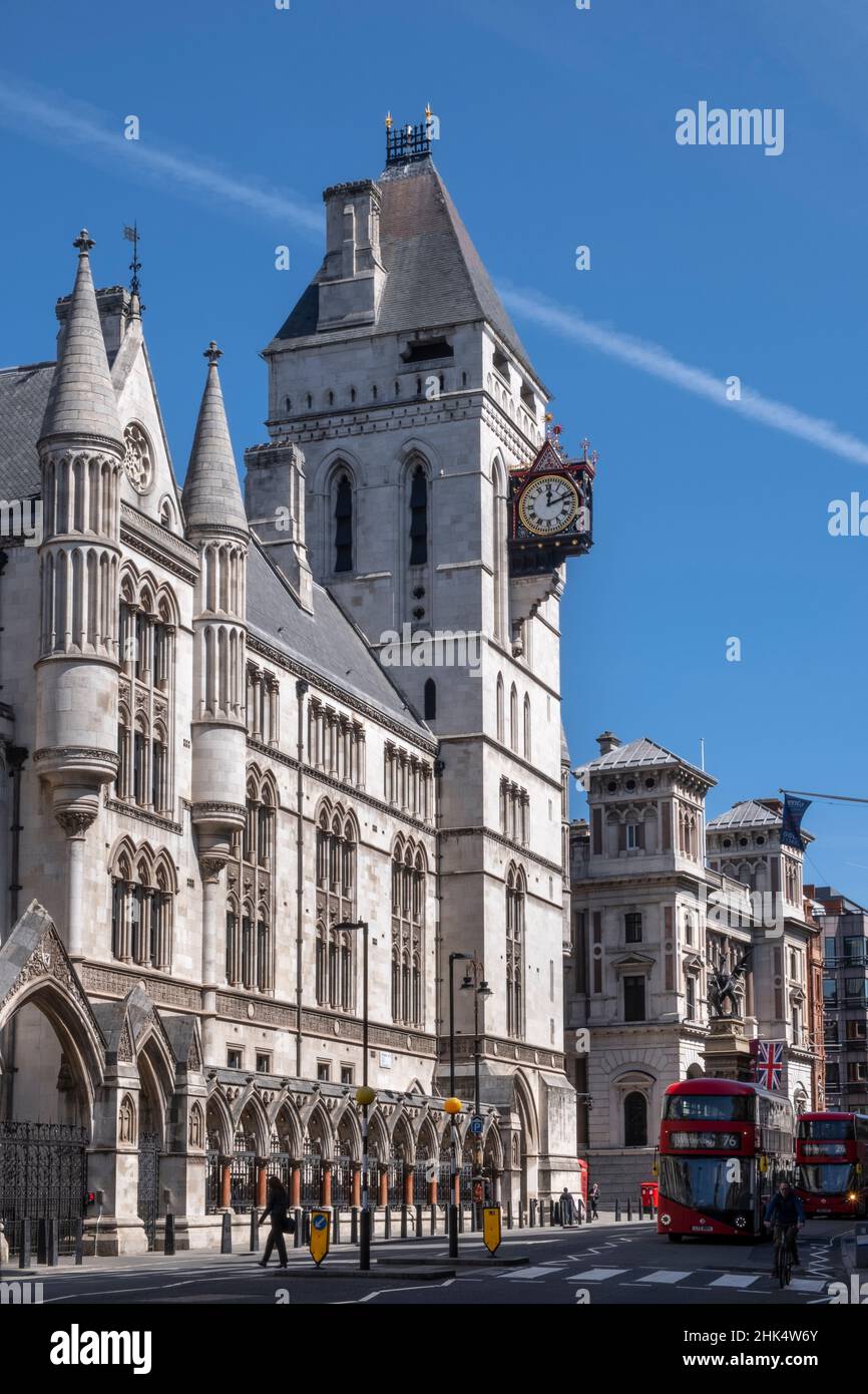 The Royal Courts of Justice, Central Civil Court, and red London bus on Fleet Street, Holborn, London, England, United Kingdom, Europe Stock Photo
