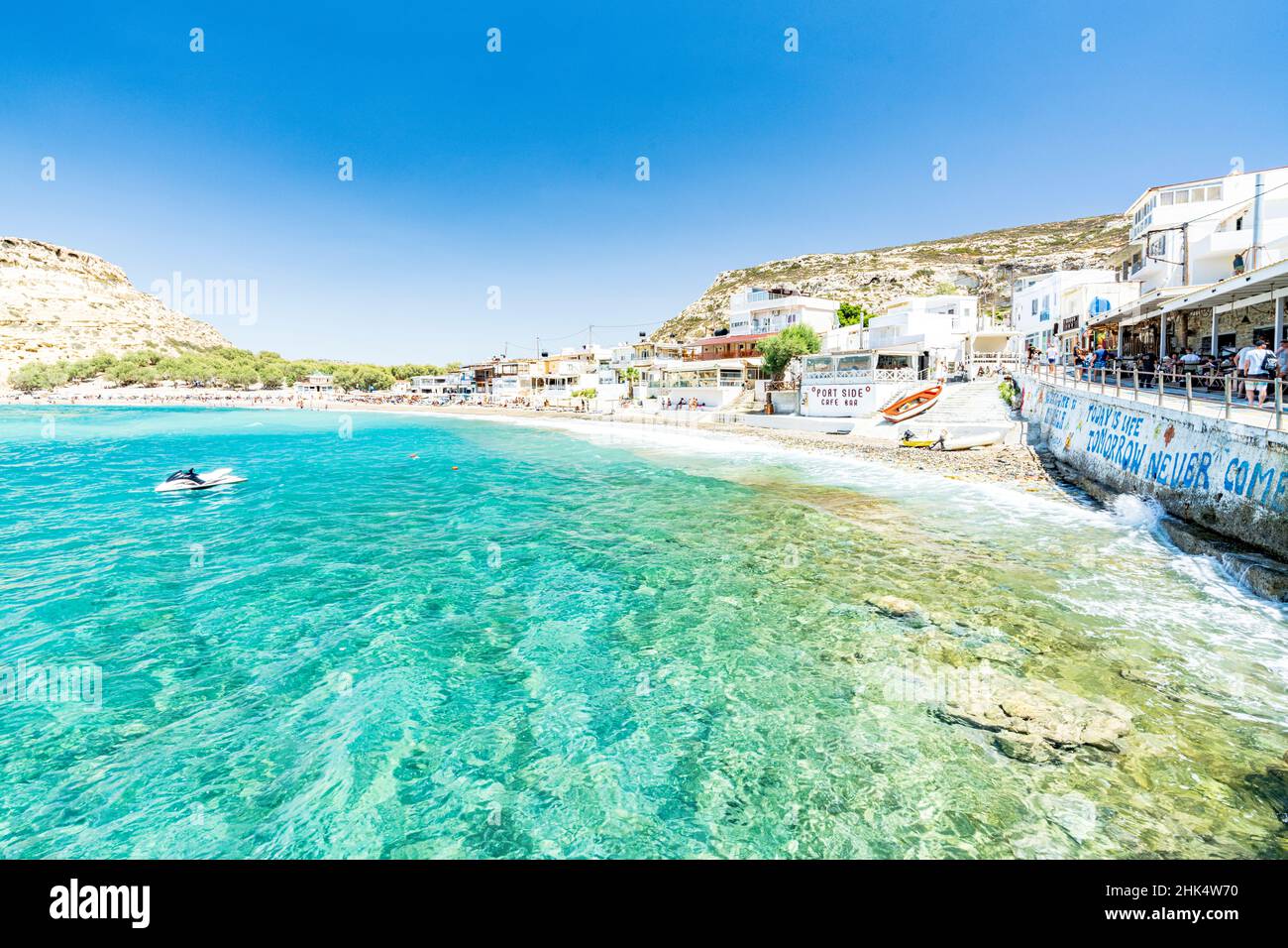 Beach of the seaside town resort of Matala washed by turquoise sea, Crete, Greek Islands, Greece, Europe Stock Photo