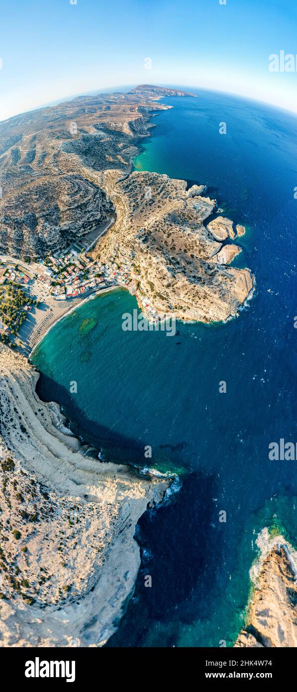 Aerial panoramic view of cliffs surrounding the beach of Matala seaside town, Crete, Greek Islands, Greece, Europe Stock Photo