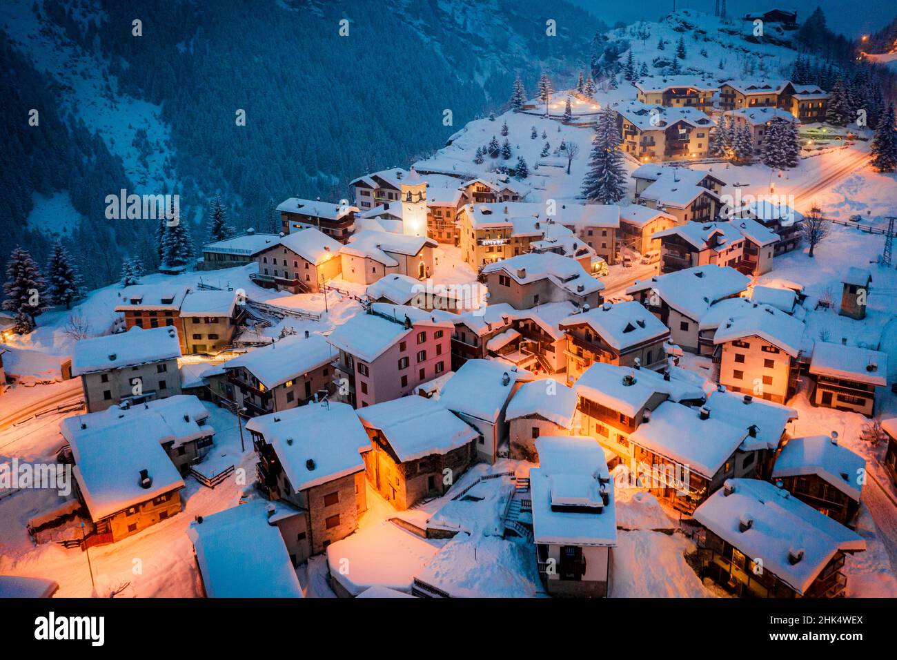 Christmas lights on mountain houses and chalets covered with snow at dusk, Pianazzo, Madesimo, Valle Spluga, Valtellina, Lombardy, Italy, Europe Stock Photo