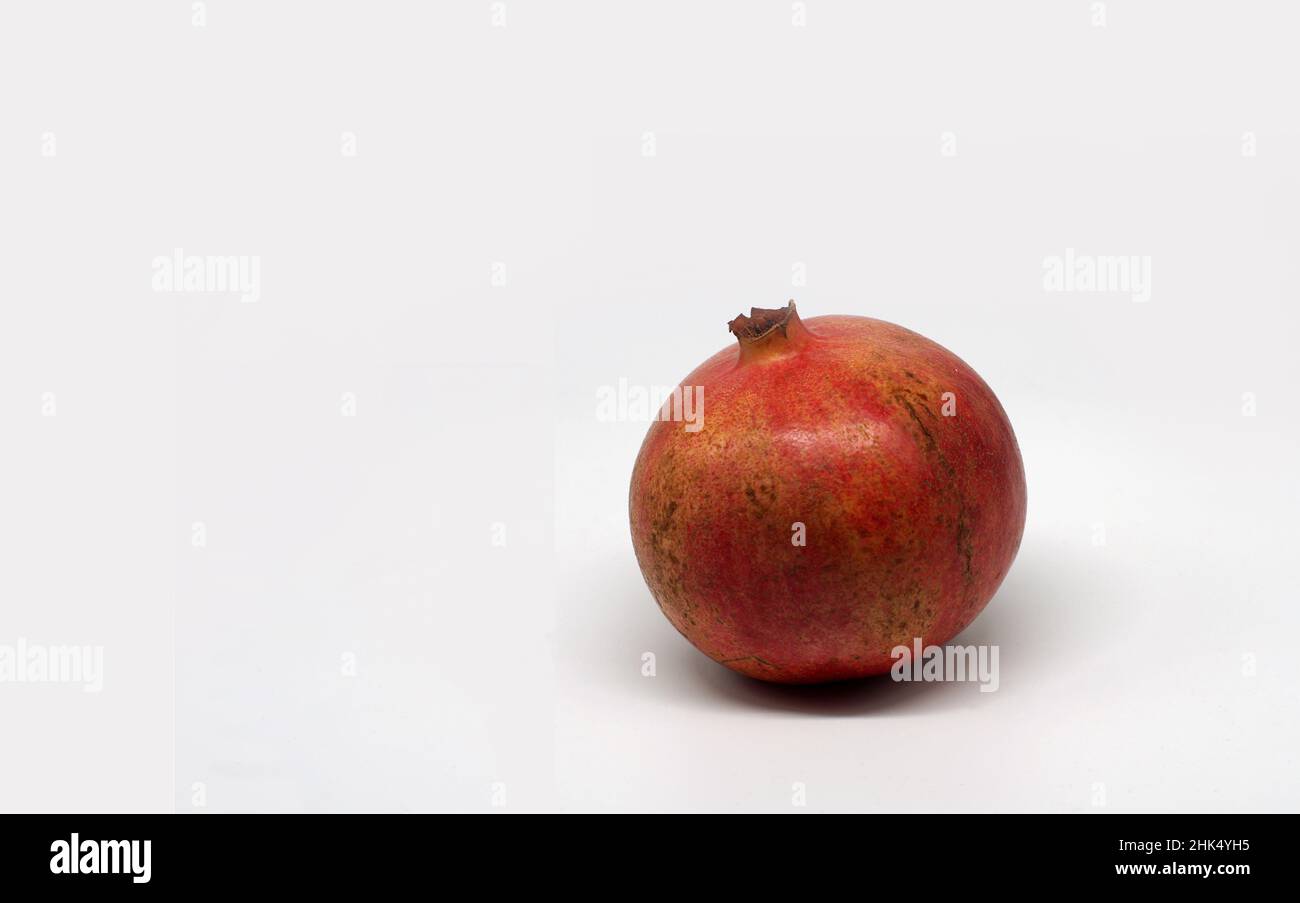 Red pomegranate isolated on white background Stock Photo