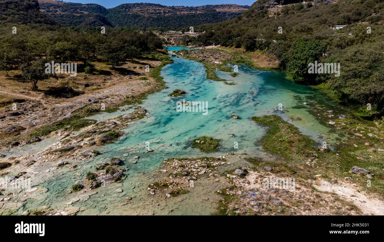 Aerial of a turquoise river in Wadi Darbat, Salalah, Oman, Middle East Stock Photo