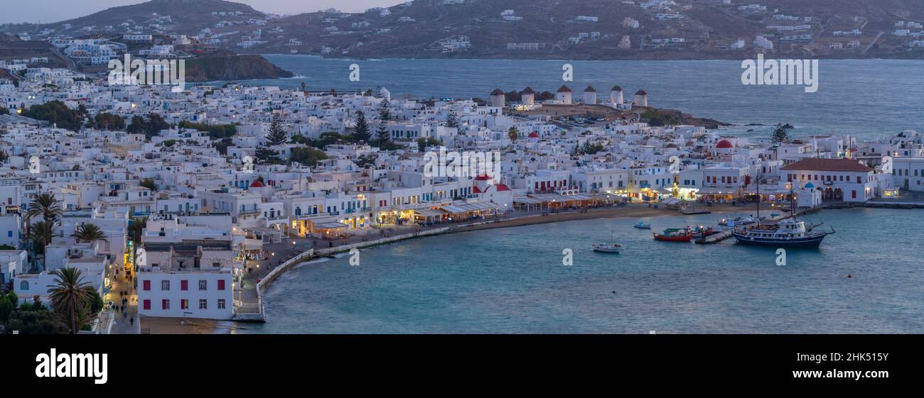 View of windmills and town from elevated view point at dusk, Mykonos Town, Mykonos, Cyclades Islands, Greek Islands, Aegean Sea, Greece, Europe Stock Photo