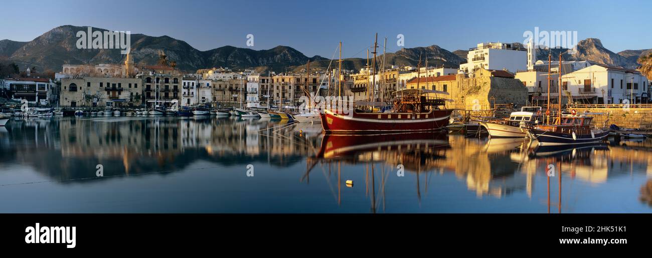 The boat filled harbour and mountains with mirror reflection, Kyrenia (Girne), Northern Cyprus, Cyprus, Mediterranean, Europe Stock Photo