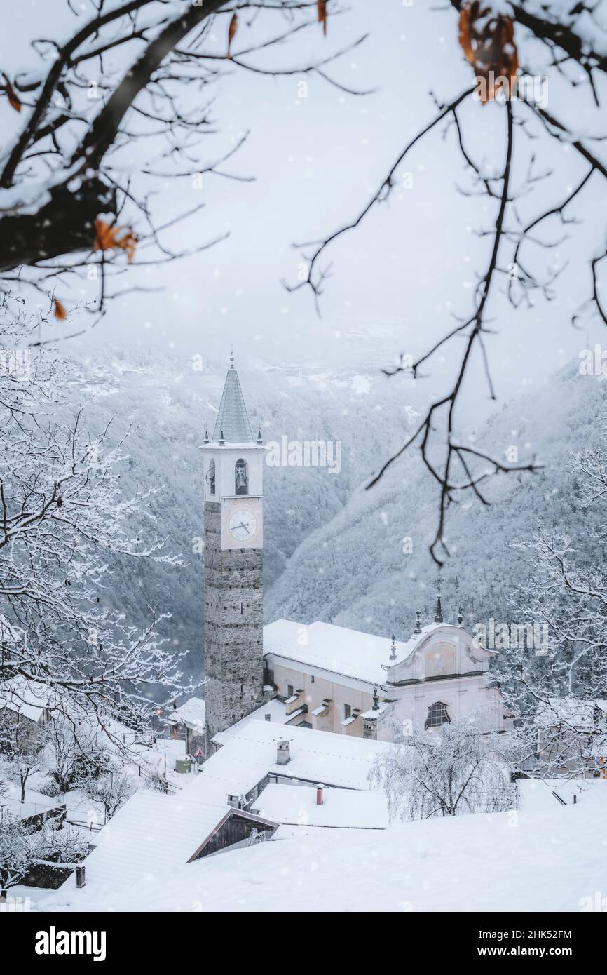Fairy tale village and bell tower after a winter snowfall, Sacco, Val Gerola, Valtellina, Sondrio province, Lombardy, Italy, Europe Stock Photo