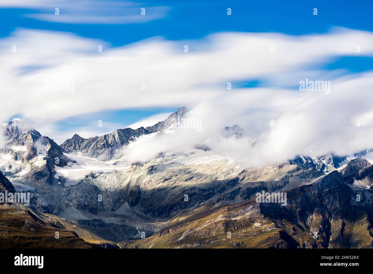 Zinalrothorn and Wellenkuppe mountains emerging from cumulus clouds, Valais Canton, Swiss Alps, Switzerland, Europe Stock Photo