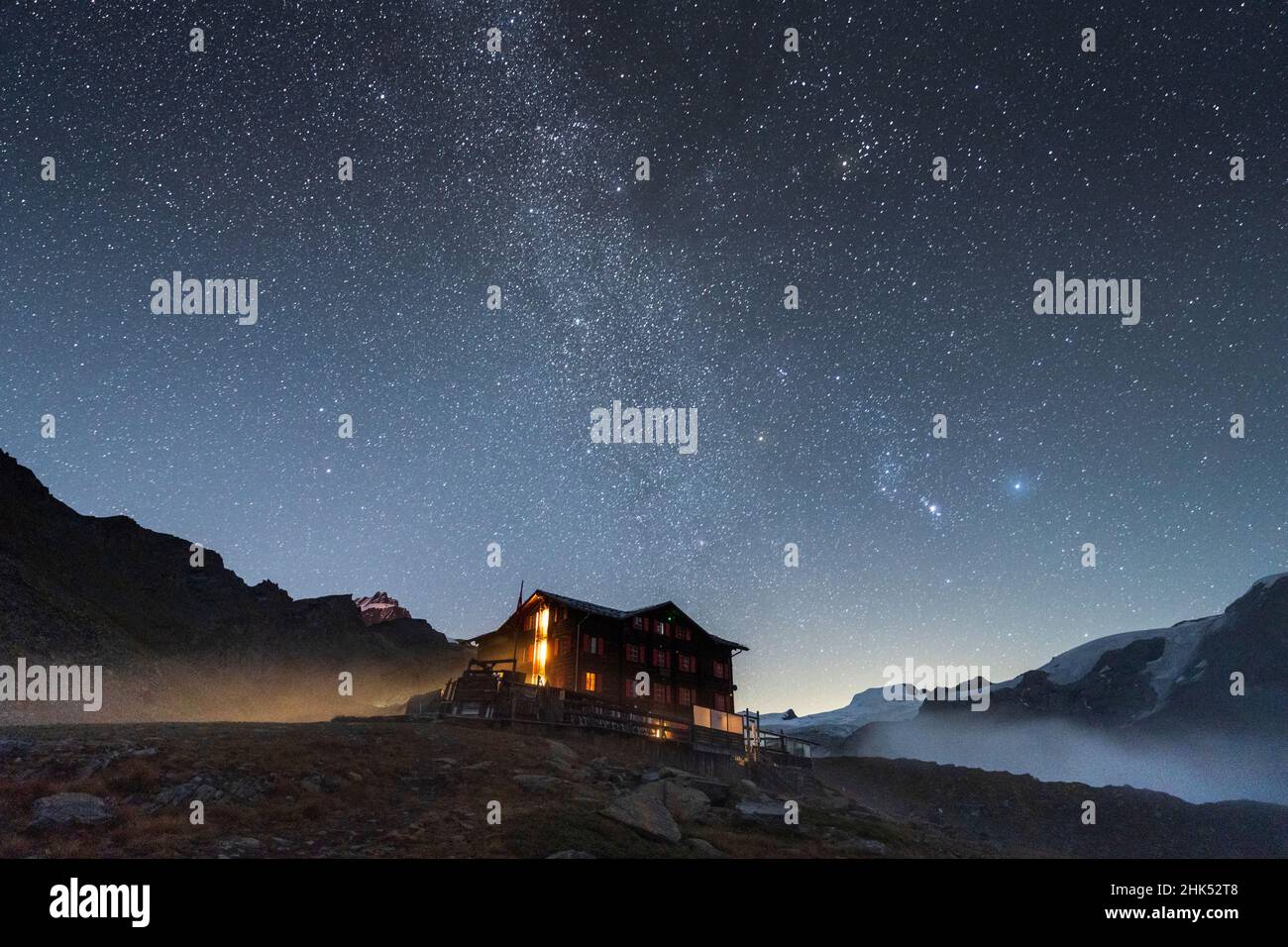 Illuminated mountain hut hotel under the stars, Fluhalp, Zermatt, Valais Canton, Switzerland, Europe Stock Photo