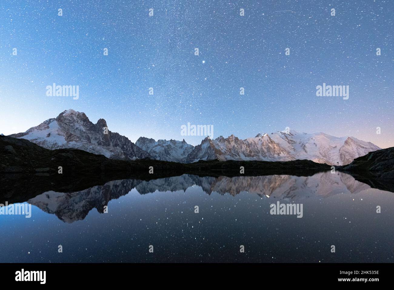 Starry sky over the snowcapped Mont Blanc, Grand Jorasses, Aiguille Vert reflected in Lacs de Cheserys, Haute Savoie, French Alps, France, Europe Stock Photo