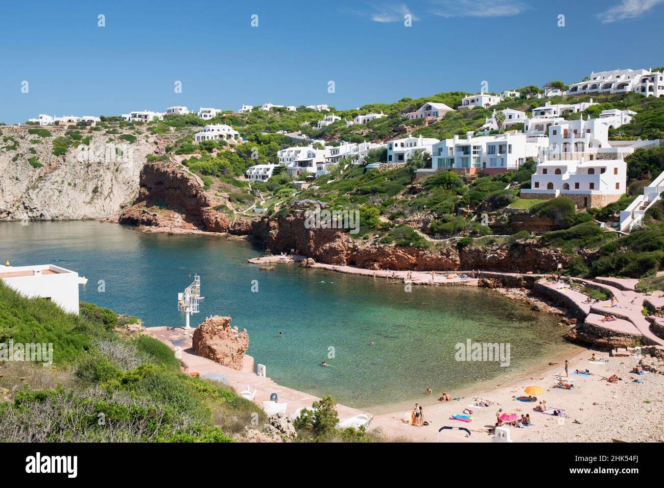 View over sandy beach to residential hillside above bay of clear turquoise water, Cala Morell, Menorca, Balearic Islands, Spain, Mediterranean, Europe Stock Photo